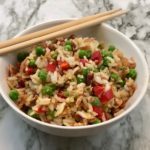 Bacon Fried Rice is a delicious fried rice recipe with veggies and bacon for a yummy flavor. Your family will love this recipe as a side dish or an easy main dish. #Sides #easyrecipes #bacon #AsianRecipes #FriedRice