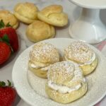 Deliciously light cream puffs filled with fresh whipping cream and strawberries.