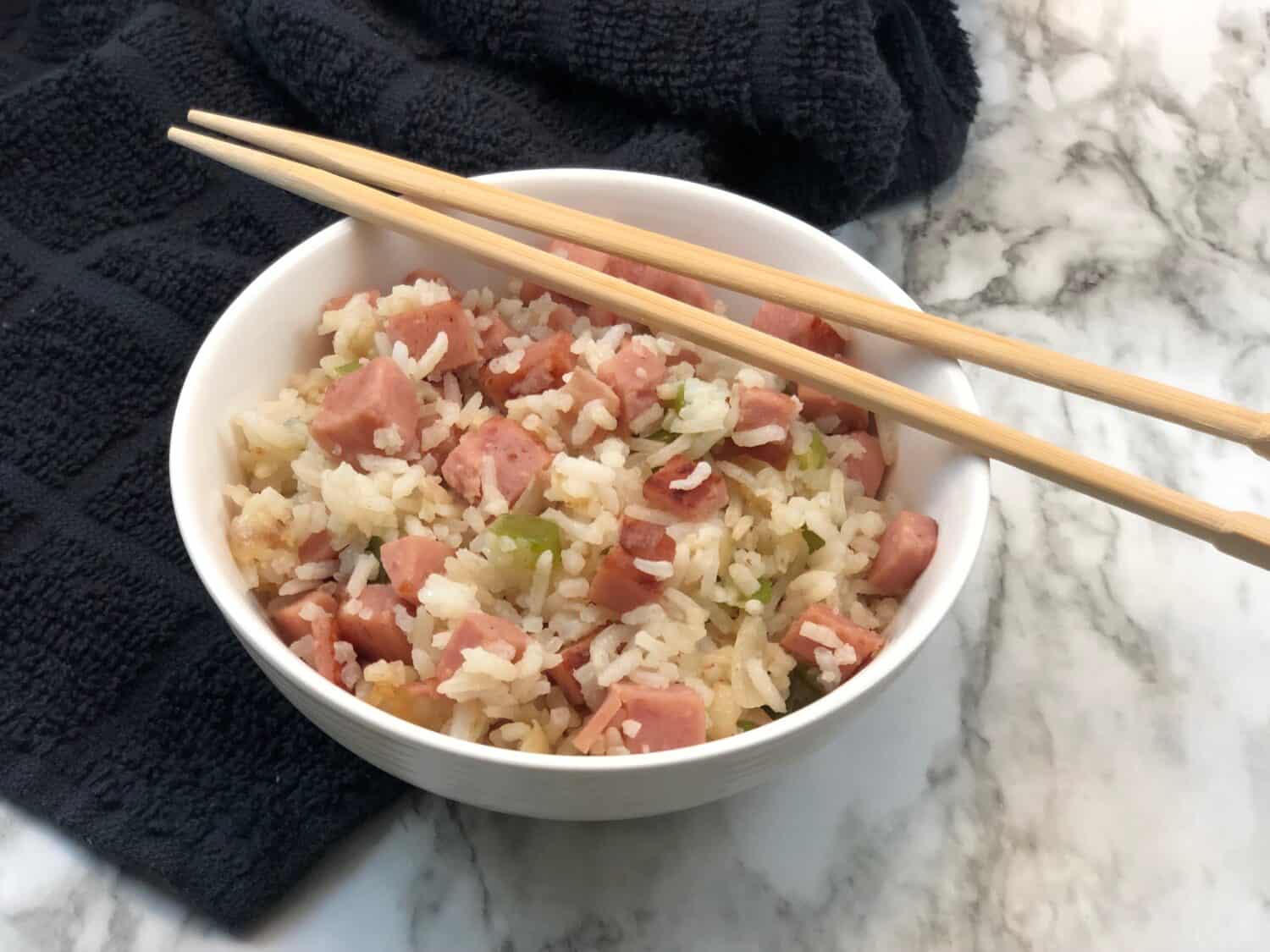 Spam Fries Rice is a super easy dinner recipe idea. It is filled with rice, spam, onion, green pepper and a delicious sauce. #Spam #AsianRecipes #FriedRiceRecipes #EasyDinnerRecipes