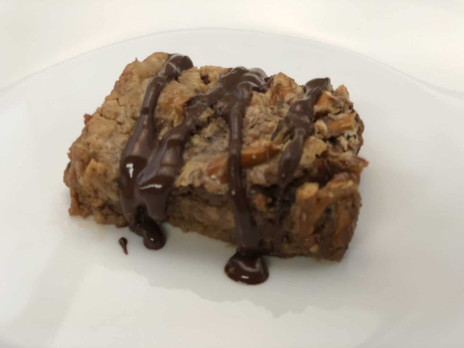 Reese's Peanut Butter Cup Pretzel Cookie Bars are rich and delicious. These cookie bars start with a graham cracker crust then they are topped with Reese's peanut butter cups and pretzels. #CookieBars #Desserts #ReesesPeanutButterCups #Pretzels #Chocolate