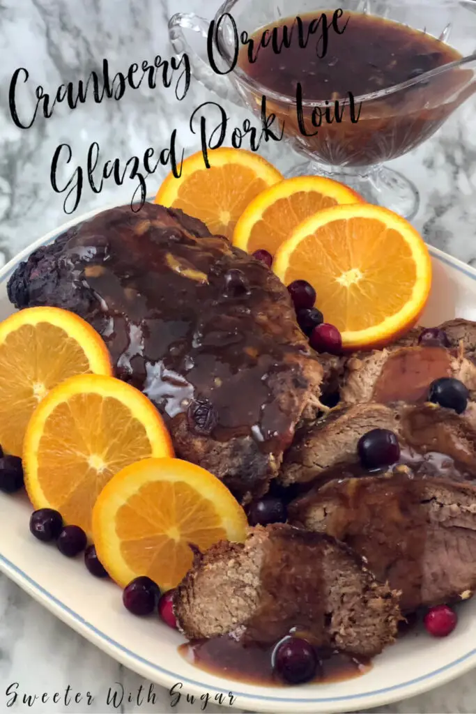 Cranberry Orange Glazed Pork Loin is a perfect slow cooker recipe you will love for the holidays. The orange and cranberry flavors go so well with the tender pork loin. #HolidayRecipes, #PorkLoin #SlowCooker #Crockpot #EasyRecipes #DinnerRecipes #Christmas #Thanksgiving