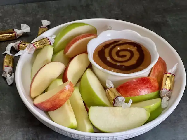Hot Fudge Caramel Apple Dip is simple and delicious. It is perfect for snacking, parties and desserts. It is perfect for Halloween and Thanksgiving. #Fall #Holidays #Halloween #AppleDip #Caramel #HotFudge #Thanksgiving #EasyDessertIdeas #PartyIdeas