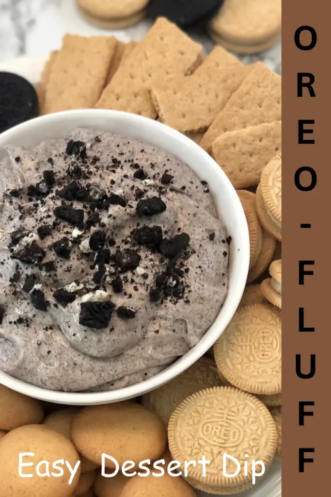 Oreo cookie dessert dip topped with crushed Oreos and served with cookies for dipping.