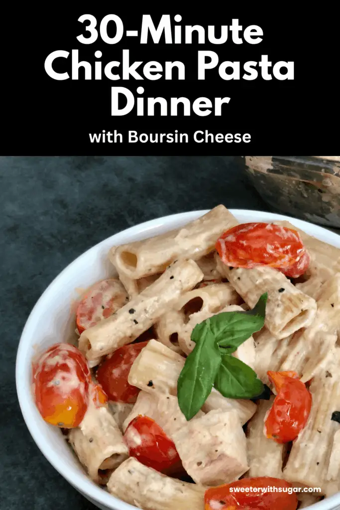 a white bowl of caprese chicken and pasta with tomatoes and basil.