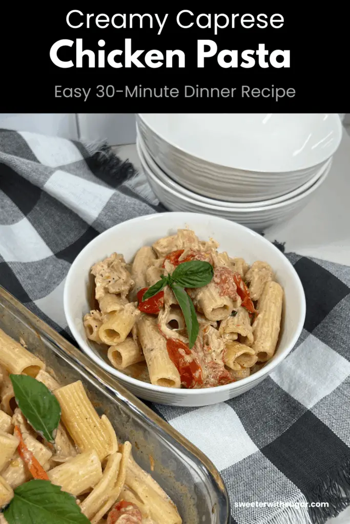 A white bowl filled with caprese chicken pasta with a boursin cheese sauce.