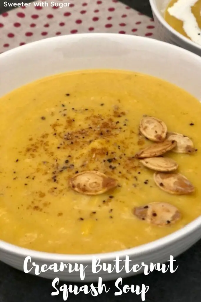 Creamy Butternut Squash Soup is an easy and yummy soup recipe with lots of vegetables. Top it with some extra cream, cajun seasoning and pumpkin seeds for some extra goodness. #Soup #ButternutSquash #SlowCooker #FallSoups