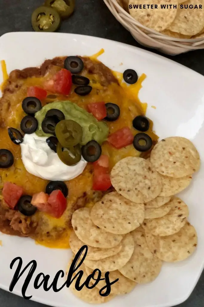 Nachos are a super easy dinner idea for busy nights. This recipe is loaded with yummy ingredients that are likely in your pantry. #Nachos #EasyWeeknightDinners #PantryMeals #MexicanRecipes #Snacks #Appetizers #NachoBar