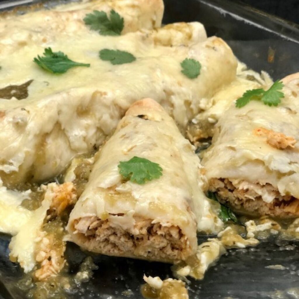 Salsa Verde Chicken Enchiladas are an easy dinner recipe filled with tender chicken and spices. Then, covered in Herdez Salsa Verde sauce and cheese. #Enchiladas #Chicken #EnchiladaCasserole #EnchiladasChicken #DinnerIdeasEasy #ChickenBreastRecipes