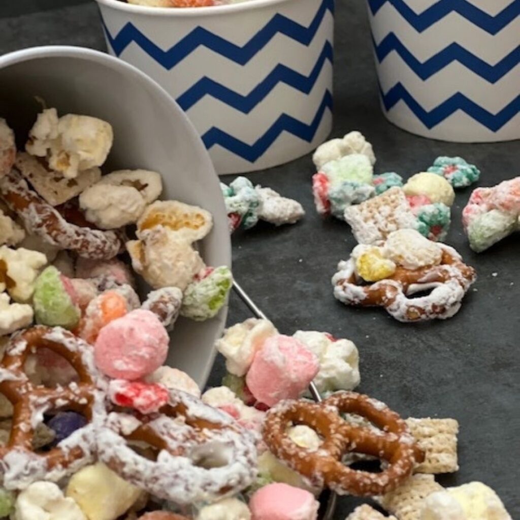 Easter Snack Mix is a fun, colorful, yummy snack the kids will love. This snack mix is perfect for Easter and spring. #ChexMix #Trix #Sixlets #RiceChex #CandyMelts #HolidayRecipes #Easter #SpringTreats #FamilyFun #EasySnacks