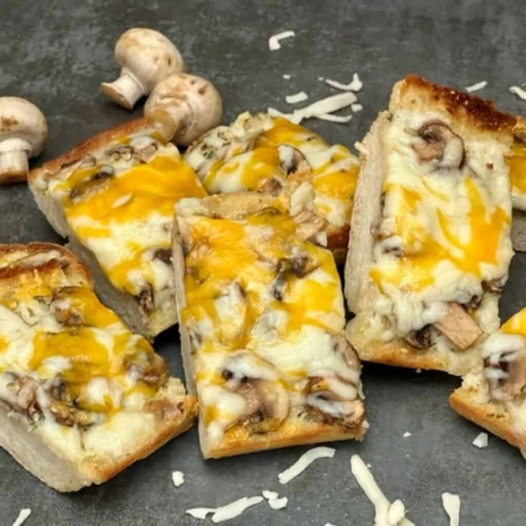 Garlic Mushroom Cheesy Bread is a simple and yummy side recipe that goes so well with many main courses. #FrenchBread #GarlicBread #CheesyBread #EasyBreadSides #Bread #Garlic #Mushrooms #Cheese