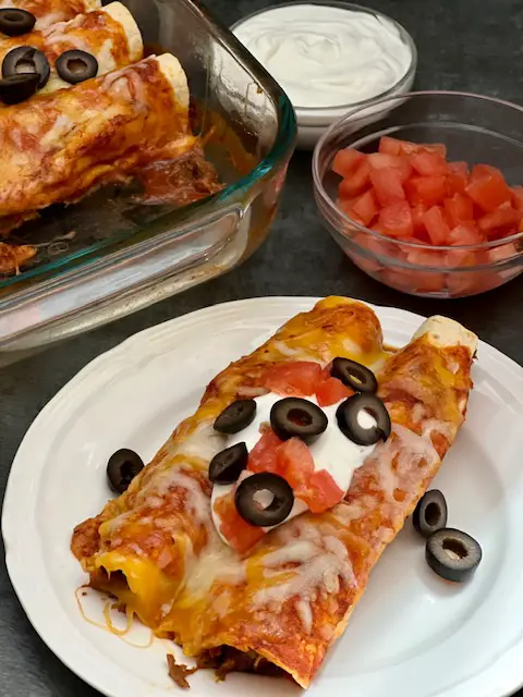 Beef Jalapeño Enchiladas are a delicious dinner recipe with a little heat. The tender beef with the jalapeños and red enchilada sauce tastes fantastic. #EasyDinner #Enchiladas #BeefRecipes #SlowCookerRecipes #Mexican #SpicyRecipes #Jalapenos 