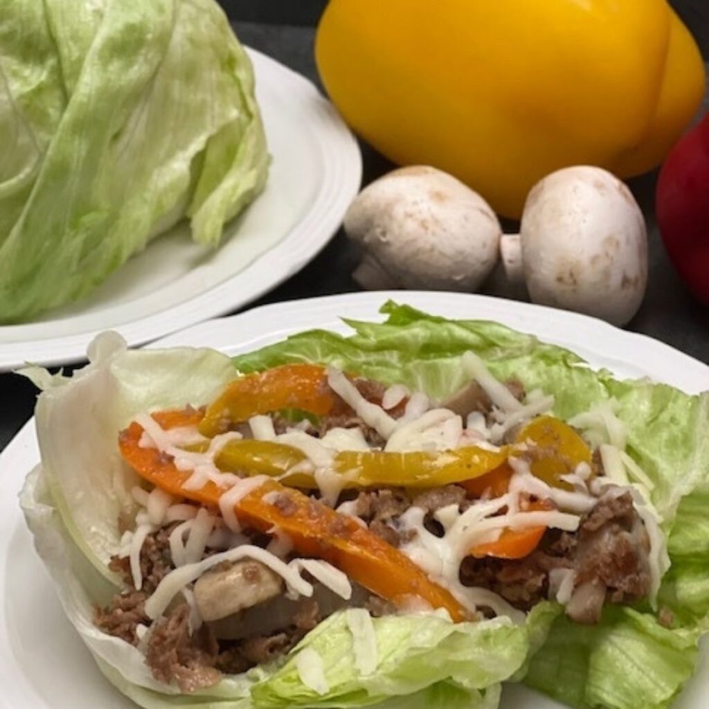 Philly Cheesesteak Lettuce Wraps are a fun and delicious dinner idea. They are filled with steak, onion, bell peppers, mushrooms, cheese and served in leaves of lettuce. #PhillyCheesesteak #LettuceWraps #Beef #Steakumms #Beef #DinnerIdeas #DinnerRecipes #EasyDinners