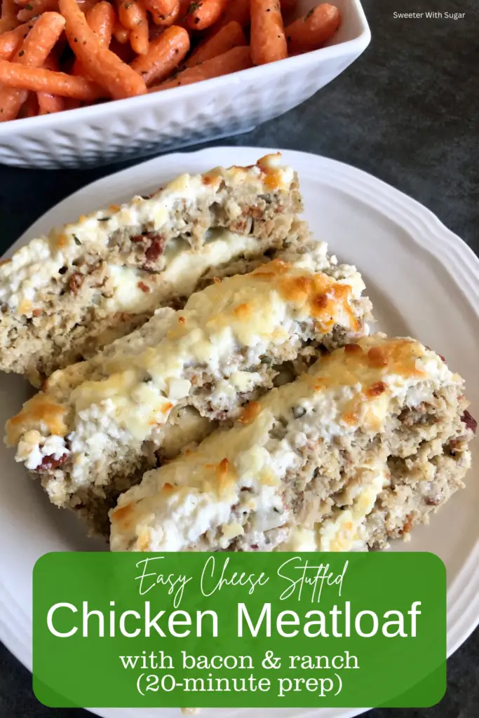 Chicken meatloaf on a plate topped with ranch dressing and filled with cheese and bacon crumbles.