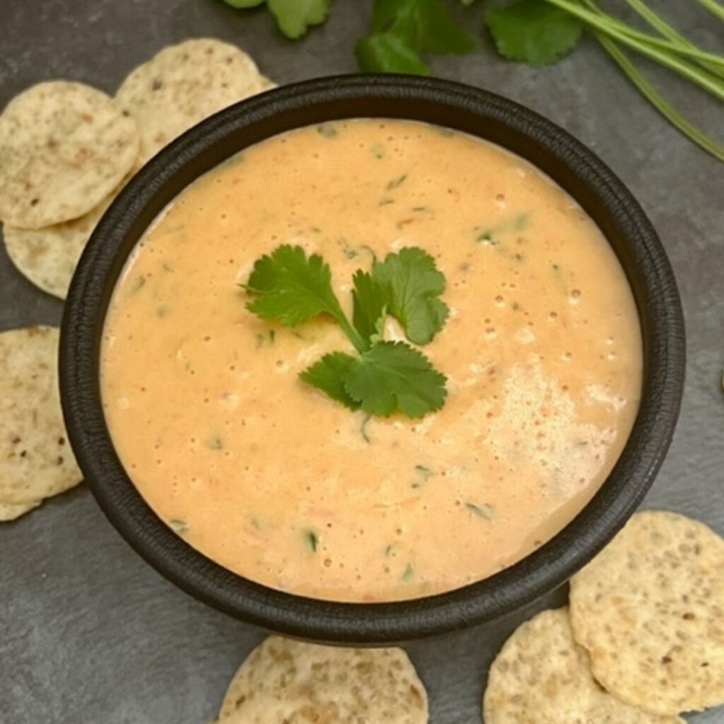 Copycat Cafe Rio Queso is a super quick and simple cheese dip recipe. This cheese dip goes great with tortilla chips, over burritos and on tacos. #CheeseDip #Queso #CafeRio #Velveeta #Rotel #CopycatRecipes #FamilyRecipes