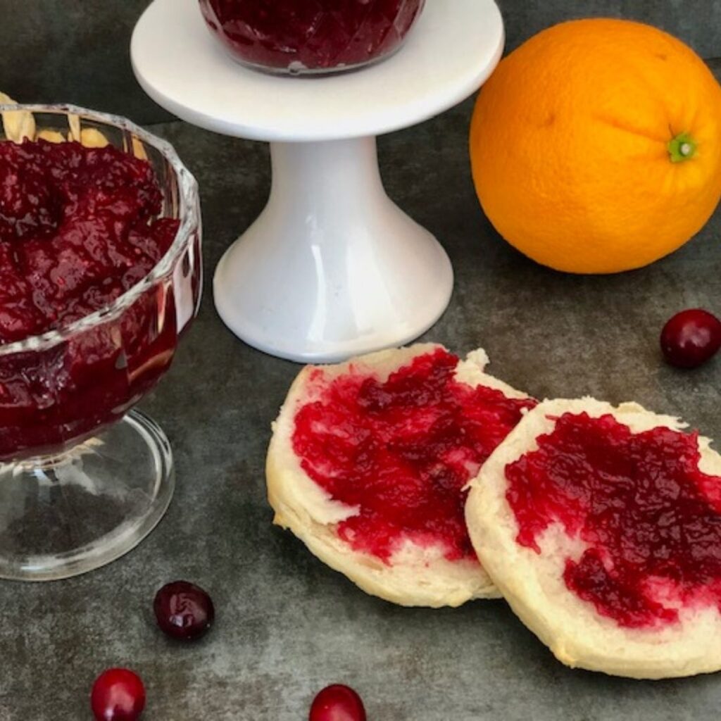 Cranberry Orange Jam is a simple and delicious jam recipe that is perfect for the holidays. It tastes wonderful and is so pretty! Plus it uses no Pectin. #JamRecipes #Cranberry #Orange #NoPectinJam #HomemadeJam