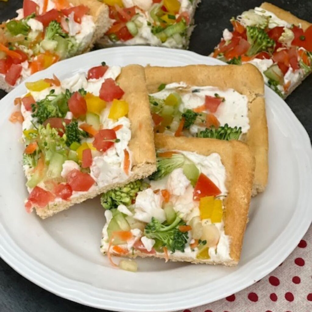 Veggie Pizza is a fun and yummy appetizer, side or even a dinner recipe! The crescent rolls with the cream cheese layer plus the veggies make this recipe perfect. #EasyAppetizers EasyRecipes #Pizza #Veggies #VeggiePizza 