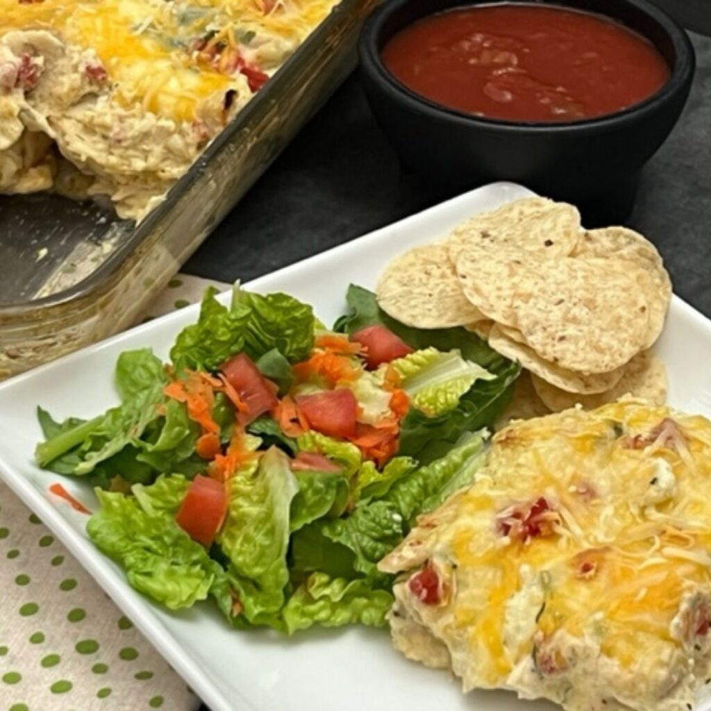 Avocado Salsa Chicken Enchilada Casserole is an easy weeknight dinner recipe you will love to make and eat. It is tender chicken in a creamy sauce between layers of corn tortillas. #DinnerRecipes #Enchiladas #Casseroles #PaceAvocadoSalsa 