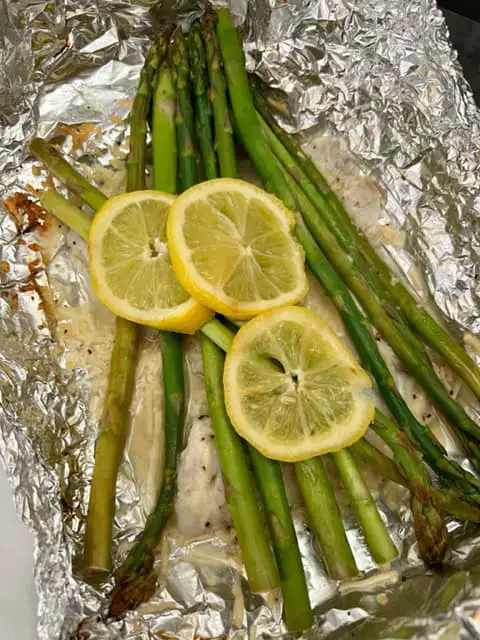 Grilled Lemon Tilapia is a super simple dinner recipe that tastes great and leaves very little clean up. #Fish #Grilling #Tilapia #GrilledTilapia #EasyDinners #Lemon 