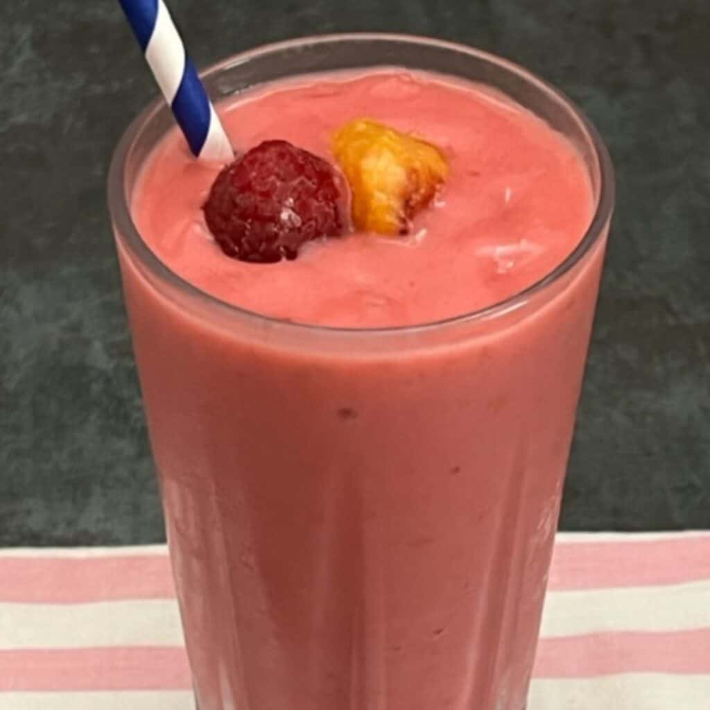 Raspberry Peach Smoothie is a smooth and creamy breakfast recipe. This smoothie has great flavor and it is quick and easy to make. #Breakfast #BreakfastSmoothies #Smoothies #DrinkRecipes #HealthyBreakfastDrinks