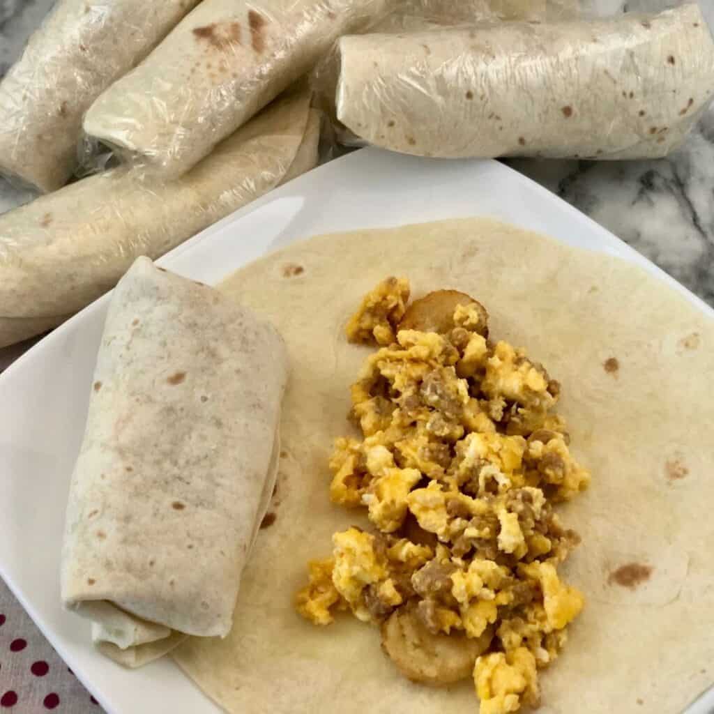 Make-Ahead, Freezer Friendly Breakfast Burritos are perfect for busy mornings. The kids will love them before school. #FreezerMeals #Burritos #Breakfast #EasyRecipes #Eggs #Sausage #Turkey