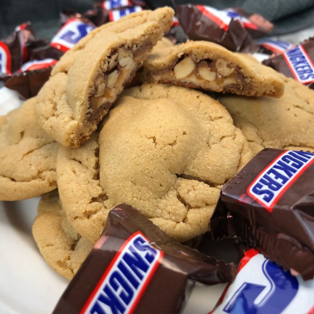 Stuffed Peanut Butter Cookies are delicious. We have stuffed these with mini Snickers. We also like to stuff peanut butter cookies with other candy bars, too. #Cookies #PeanutButterCookies #Snickers #StuffedCookies