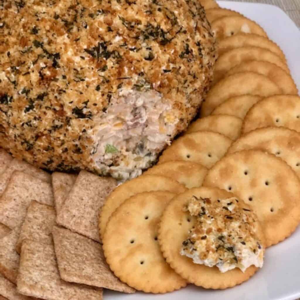 Jalapeño Popper Cheese Ball is a flavorful cheese ball filled with cream cheese, cheddar and parmesan cheeses, jalapeños and more. If you love jalapeño poppers, you will love this cheese ball.#JalapenoPopper #CheeseBall #Appetizers #PartyFoods #SuperBowl