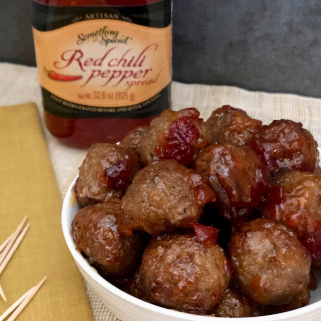 Red Chili Pepper Meatballs are a quick and easy appetizer that requires only two ingredients. Your guests will love the flavor of this Red Chili Pepper Spread on meatballs. #Appetizers #TwoIngredientRecipes #Meatballs #RedChiliPepper #PartyFood 