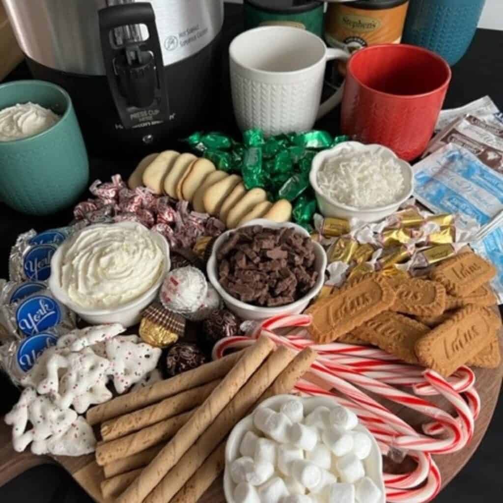 Hot Cocoa Charcuterie Board is a fun addition to any winter party. They are fun to fill with all kinds of chocolate, mint, caramel, strawberry, raspberry-anything fun and flavorful. #HotCocoa #CharcuterieBoards #PartyIdeas #Christmas #HolidayPartyIdeas #HotChocolate