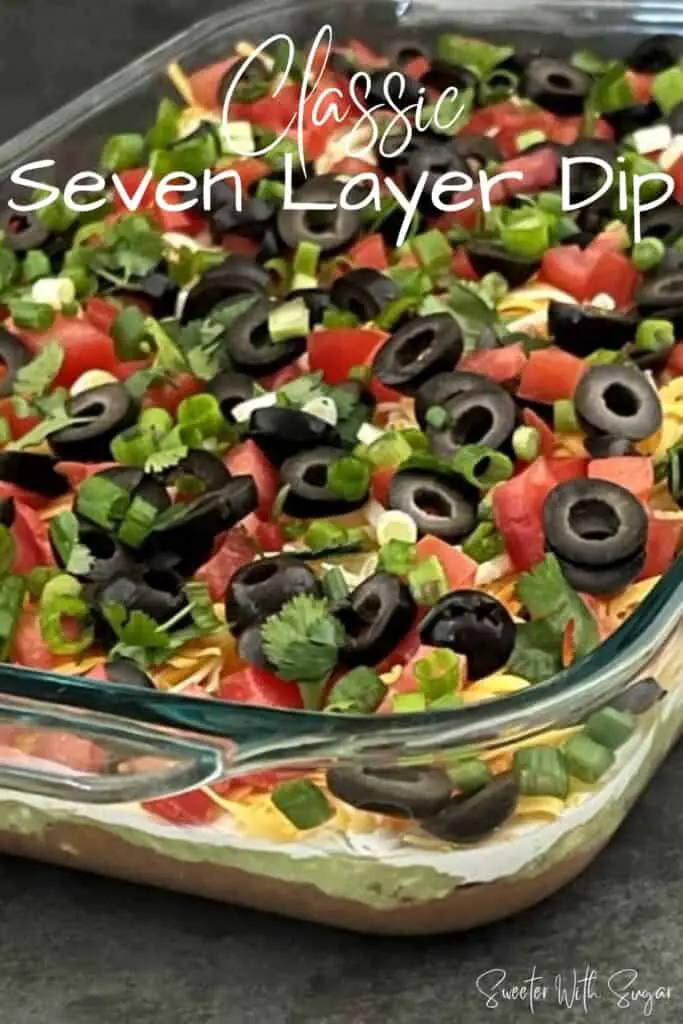 Classic Seven Layer Dip is a yummy appetizer for any get-together. This dip is filled with delicious ingredients and is easy to make. #SuperBowl #PartyFood #ClassicRecipes #7LayerDipRecipe #LayeredDip