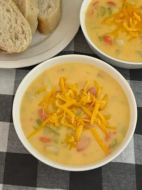 Cheddar Cheese Potato Soup is a delicious homemade soup that is thick and cheesy. You will love this comfort food recipe. #HomemadeSoup #SoupRecipes #CheddarCheeseSoup #CreamyVegetableSoup #ComfortFood 