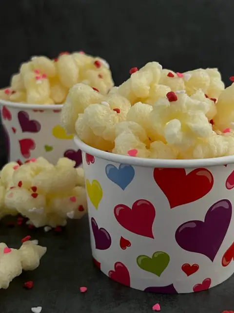Strawberry Corn Pops is a fun and yummy treat for Valentine's Day! This is a simple and quick recipe you will love. #CornPops #CornPuffs #PriatesBooty #CloverClubCornPops #CaramelCorn #Strawberry #ValentinesDayIdeas #ValentinesDayRecipes