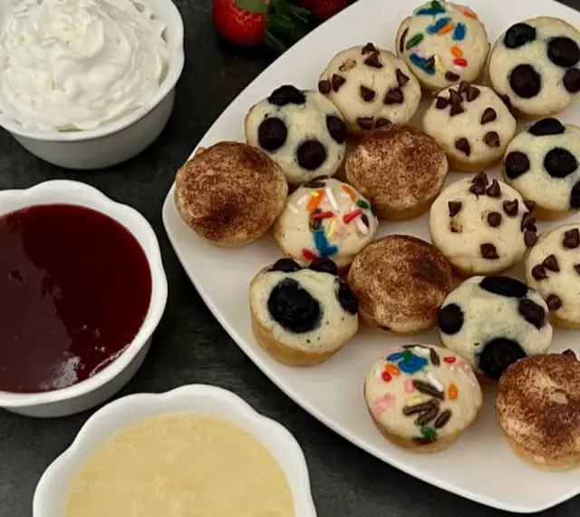 Mini Pancakes are a fun and yummy breakfast idea you can eat with your hands. They are quick to make-you bake them all at once. This is an easy breakfast recipe. #Pancakes #BakedPancakes #EasyRecipes #KidFriendly #FunBreakfastIdeas