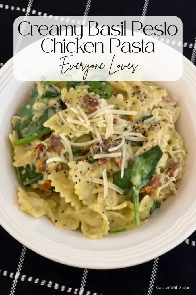 A comforting bowl of creamy basil pesto chicken pasta topped with parmesan cheese. 