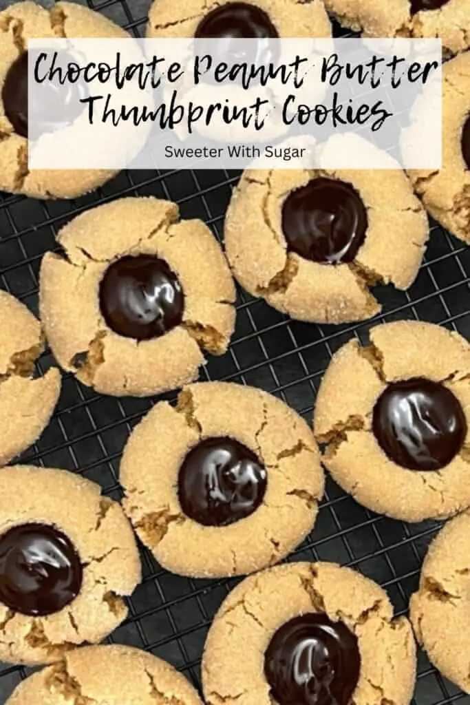 Chocolate Peanut Butter Thumbprint Cookies are an easy cookie recipe. These cookies are cute and delicious! The soft peanut butter cookie is rolled in sugar and the middle is filled with a chocolate ganache filling you will love! #ChocolateGanache #PeanutButterCookies #Cookies #ChocolatePeanutButterCookies #ThumbprintCookies #PeanutButterBlossoms #EasyCookieRecipes #BestChristmasCookieRecipesHolidays #ChocolatePeanutButter