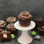 Cadbury Egg Cupcakes are a simple dessert recipe for your Easter celebration. The chocolate cupcake with a Cadbury Egg inside plus the chocolate buttercream makes these cupcakes delicious! #CadburyEggs #ButterCreamFrosting #EasterEggHuntIdeas #FilledCupcakes #ChocolateCupcakes #EasterRecipes