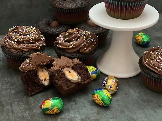 Cadbury Egg Cupcakes are a simple dessert recipe for your Easter celebration. The chocolate cupcake with a Cadbury Egg inside plus the chocolate buttercream makes these cupcakes delicious! #CadburyEggs #ButterCreamFrosting #EasterEggHuntIdeas #FilledCupcakes #ChocolateCupcakes #EasterRecipes