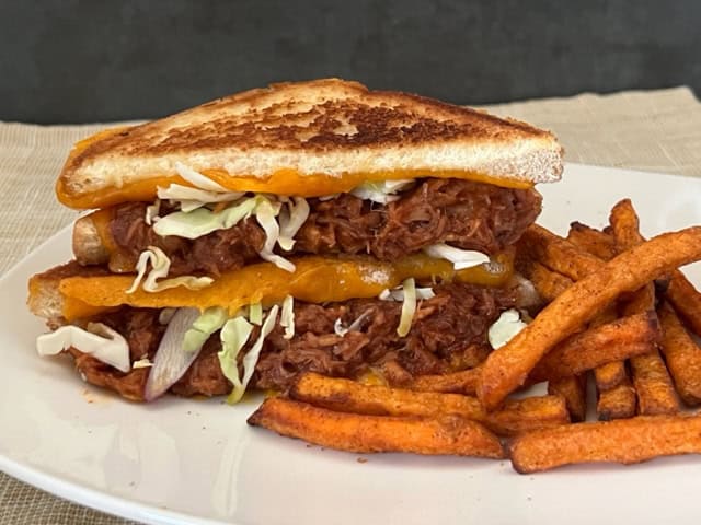 Pulled Pork Grilled Cheese is a simple recipe made with barbecue pulled pork, grilled bread covered in melty cheese. You can even use leftover barbecue pulled pork. #BarbecuePulledPork #GrilledCheese #Sandwiches #EasyDinnerRecipes #PorkRecipes