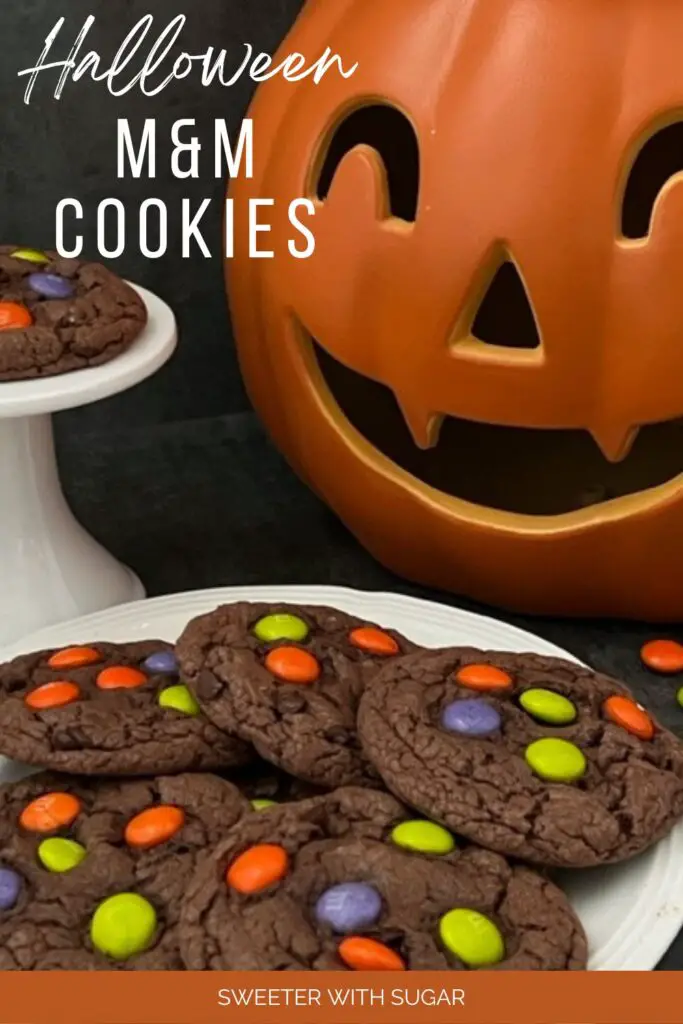 Halloween M & M Cookies are super easy to make. They are a yummy soft chocolate cookie topped with M & M's Ghoul Mix plain M & M's. They are perfect for Halloween. #Cookies #M&Ms #ChocolateCookies #CakeMixCookies #M&MsGhoulMix #EasyCookieRecipe 