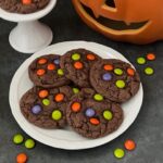 Halloween M & M Cookies are super easy to make. They are a yummy soft chocolate cookie topped with M & M's Ghoul Mix plain M & M's. They are perfect for Halloween. #Cookies #M&Ms #ChocolateCookies #CakeMixCookies #M&MsGhoulMix #EasyCookieRecipe