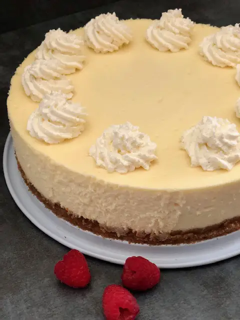 Vanilla Cheesecake is a classic dessert recipe. It is smooth and creamy and so versatile. Add raspberries, blueberries, blackberries, or other berries you like. It is also delicious with a raspberry sauce drizzled over the top. Also, it is great plain with a bit of whipping cream. #CheesecakeRecipes #DessertRecipes #VanillaCheesecake #HomemadeCheesecake