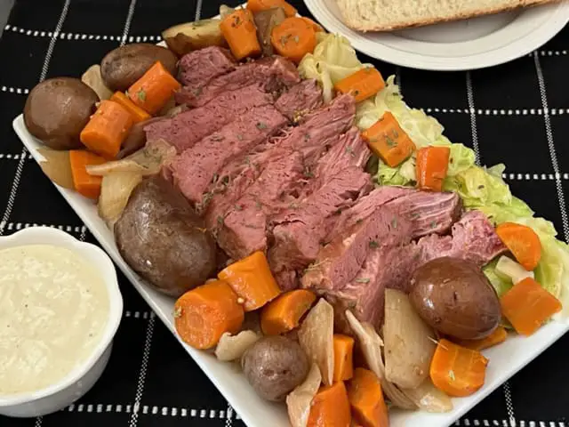 Corned Beef and Cabbage with Horseradish Sauce is the perfect meal to celebrate St. Patrick's Day. This is made in the slow cooker and turns out very tender. #StPatricksDay #CornedBeefAndCabbage #HorseradishSauce #SlowCookerRecipes #HolidayRecipes