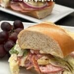 Italian Sub Sandwich is filled with four different deli meats, cheese, veggies and a delicious dressing. It is quick to make and delicious! #Subs #Sandwiches #DeliSandwiches #SubmarineSandwiches #ItalianGrinderSandwiches #Lunches #SandwichRecipes