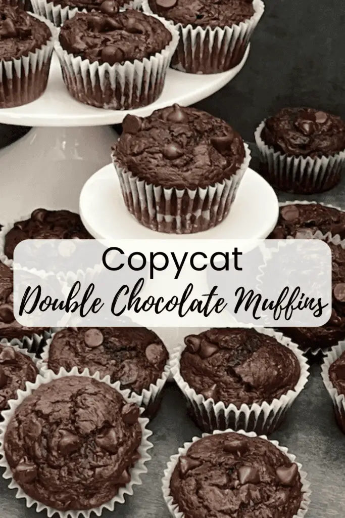 A counter top. full of double chocolate muffins with a cracked top, revealing a soft center, sitting on a white plate with chocolate chips bursting out of the top.
#DoubleChocolateMuffins #CostcoCopycat #HomemadeBakeryStyleMuffins #ChocolateLovers #MoistMuffins #EasyBaking #JumboMuffins #ChocolateCake