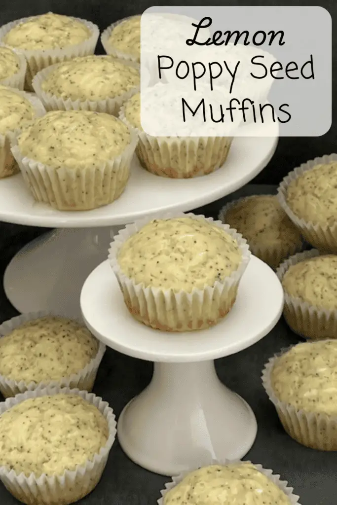 A batch of golden lemon poppy seed muffins with a light drizzle of lemon glaze, sitting on a white cake plate.
#LemonPoppySeedMuffins #EasyBaking #HomemadeMuffins #LemonLovers #SpringBaking #MoistMuffins #BreakfastIdeas
