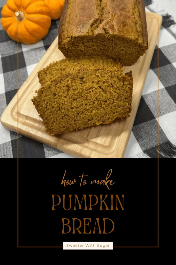 A freshly baked loaf of homemade pumpkin bread sliced to reveal its moist, golden-orange interior on a cutting board with little pumpkins. #PumpkinBread #FallBaking #PumpkinSpice #EasyBaking #MoistPumpkinBread #HomemadeBread #BakingFromScratch
