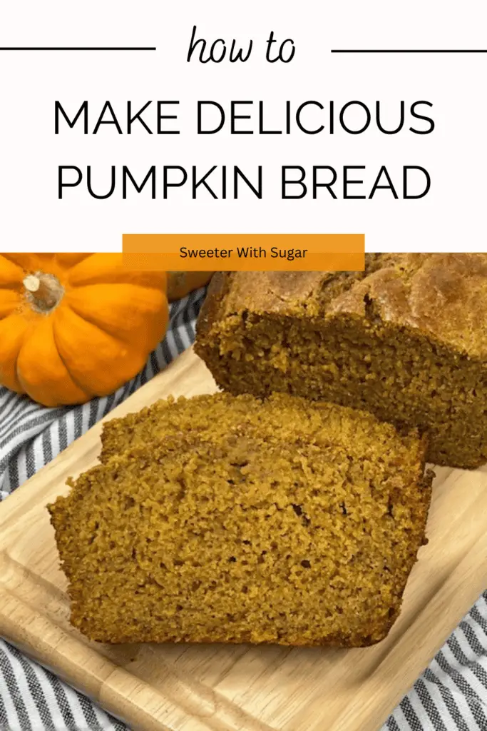 A freshly baked loaf of homemade pumpkin bread sliced to reveal its moist, golden-orange interior on a cutting board with little pumpkins. #PumpkinBread #FallBaking #PumpkinSpice #EasyBaking #MoistPumpkinBread #HomemadeBread #BakingFromScratch
