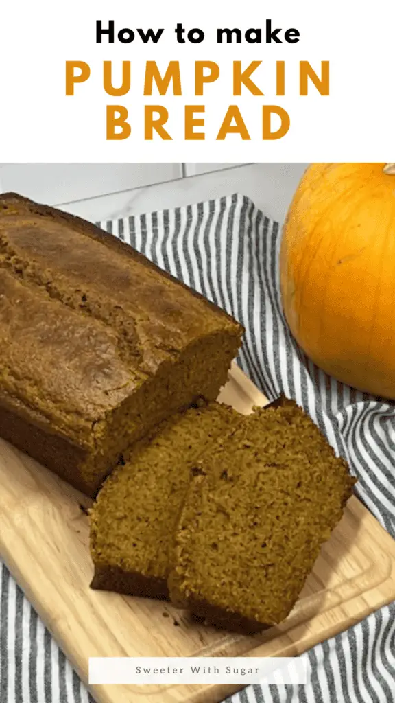 A freshly baked loaf of homemade pumpkin bread sliced to reveal its moist, golden-orange interior on a cutting board with little pumpkins. #PumpkinBread #FallBaking #PumpkinSpice #EasyBaking #MoistPumpkinBread #HomemadeBread #BakingFromScratch