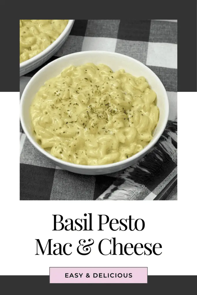 A bowl of creamy basil pesto mac and cheese with melted cheese. Topped with a bit of dried parsley.

#PestoMacAndCheese #MacAndCheeseLover #ComfortFood #EasyDinner #CheeseLover #PastaRecipes #BasilPesto