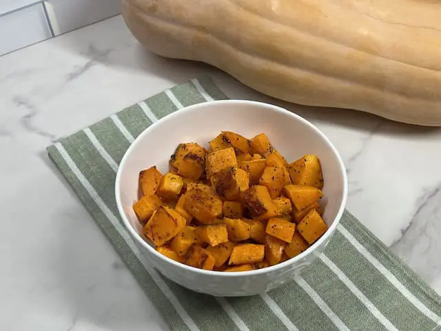 Golden roasted butternut squash pieces ready to serve as a fall side dish.