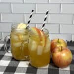 Family-friendly apple cider mocktail with apple slices served over ice.